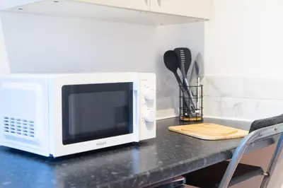 a white microwave sitting on a counter in a kitchen at Open House in Carlisle