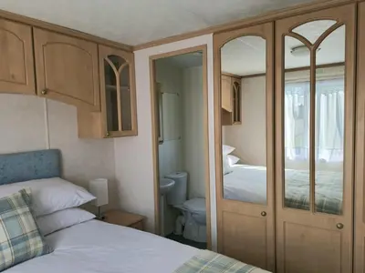 a bedroom with a bed and a toilet in a room at Penny in Whithorn