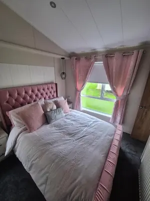 a large bed in a room with a window at 2 bedroom platinum in Minishant