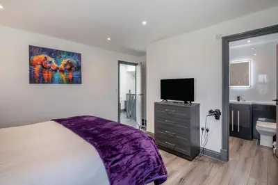 a bedroom with a bed and a tv and a bathroom at 3 Bed in Cockermouth oc-o31515 in Embleton