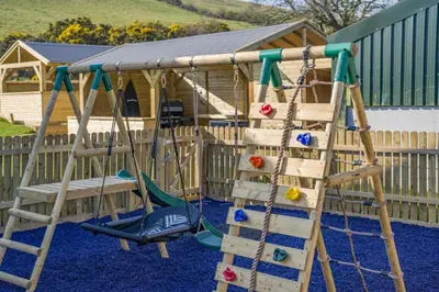 a playground with a ladder and a swing at 3 Bed in Cockermouth oc-o31515 in Embleton