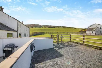 a view of a pasture from the balcony of a house at 1 Bed in Cockermouth oc-s31514 in Embleton