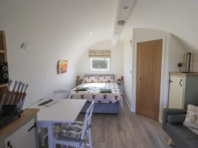 a bedroom with a bed and a desk and a table at Shepherds View in Keswick