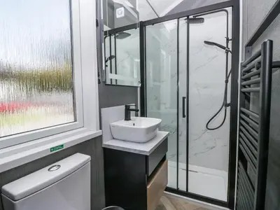 a bathroom with a sink and a shower at Sail Luxury Family Pod in Keswick