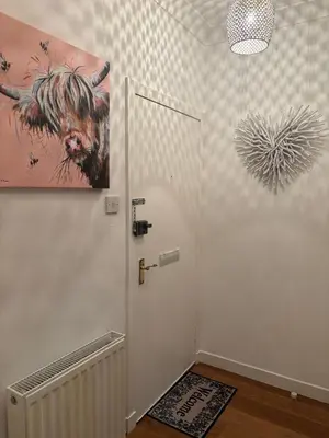 a bathroom with a door and a painting on the wall at Saltayr in Ayr