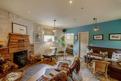 a living room filled with furniture and a fireplace at Hightae B&B in Hightae