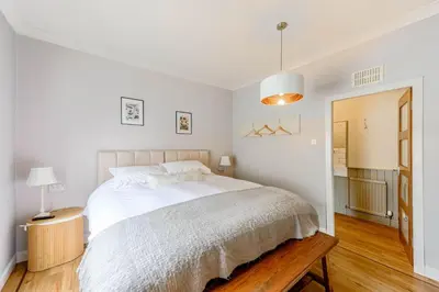 a white bedroom with a large white bed in it at Hightae B&B in Hightae