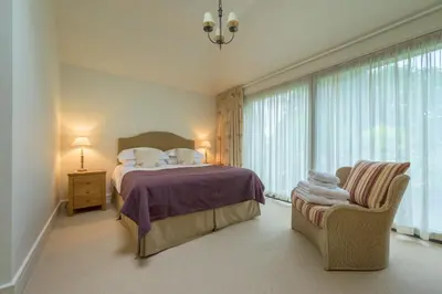 a hotel room with a bed and a chair at The School at Mungrisdale in Penrith