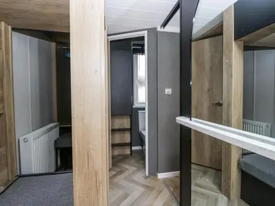 a room with wooden walls and a mirror at Dubs Luxury Family Pod in Keswick