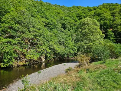 a river with trees on the side of it at Elter Luxury Pod in Keswick