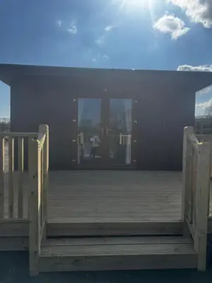 a porch with a wooden ramp to a house at Country Cabin in Hesket Newmarket