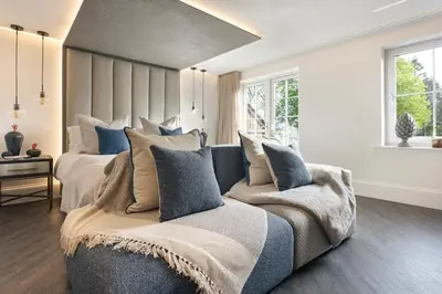 a bedroom with a large bed and a couch at The Sanctuary - Ridgestone in Watermillock