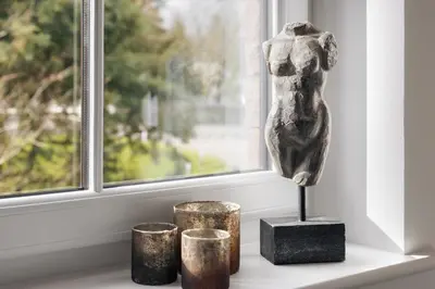 a statue on a table next to a window at The Sanctuary - Ridgestone in Watermillock