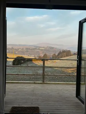 a view from a window of a train yard at The Byre, Summerhill Farm Stays in Balmaclellan
