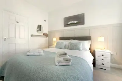 a bedroom with two white towels on a bed at 6 Harney Peak in Portinscale