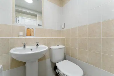 a bathroom with a toilet and a sink at 6 Harney Peak in Portinscale