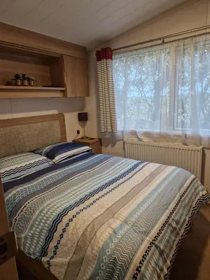 a bedroom with a bed and a window at Manannan in Maryport