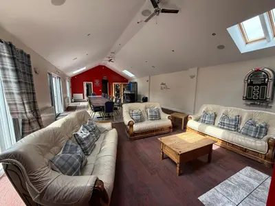 a living room with couches and a coffee table at Belton House Guest Rooms in Wanlockhead