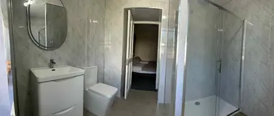 a bathroom with a sink and a toilet and a shower at Belton House Guest Rooms in Wanlockhead