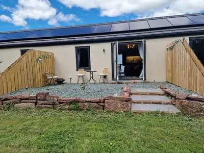 a house with a stone path in front of it at The Burrow by Blake View Holidays a peaceful boutique retreat 3 miles from Ennerdale- standard twin or super-king bed available in Rowrah