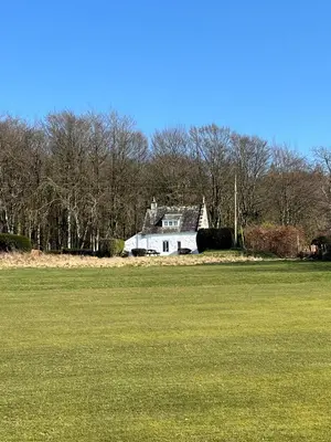 an old house in the middle of a field at Cross Cottage in Gatehouse of Fleet