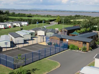 an aerial view of a tennis court and buildings at Shoreline Stay in Port Carlisle
