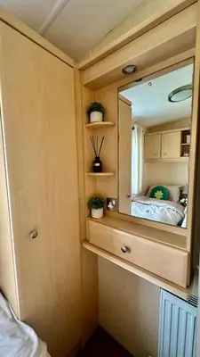 a mirror in a small room with a bed at Shoreline Stay in Port Carlisle