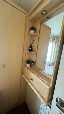 a small bathroom with a mirror and some plants at Shoreline Stay in Port Carlisle