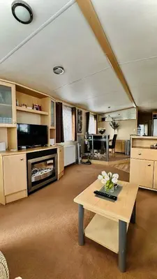 a large living room with a table and a couch at Shoreline Stay in Port Carlisle