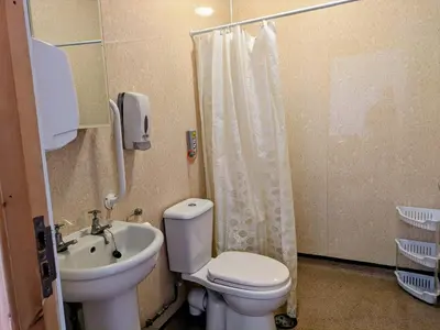 a bathroom with a toilet and a sink and a shower at Ensuite rooms, self-catering in shared kitchens in Dumfries
