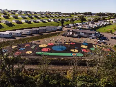 an aerial view of a park with a playground at Crofthead Holiday Park in Ayr