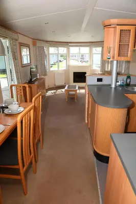 a kitchen with a table and chairs and a counter top at Shelly's Stay in Port Carlisle