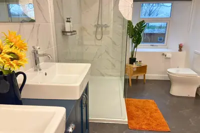 a bathroom with a sink and a shower and a toilet at Secluded Hot Tub, Pool, Escape in Bootle