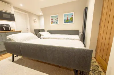 a bedroom with two beds in a room at Stoneyloft Modern Apartment in Glen Vine in Glen Vine