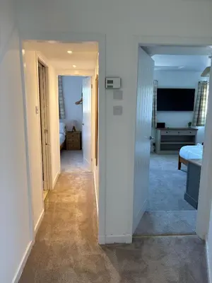 a hallway leading to a room with a bedroom at Modern 3-Bedroom, central Kirkcudbright in Kirkcudbright