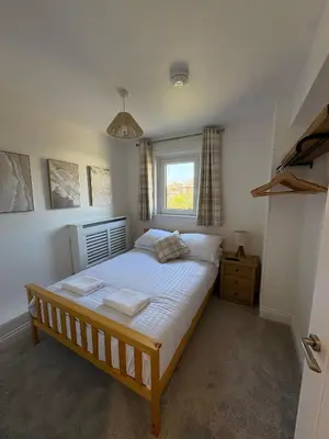 a bedroom with a bed and a window at Modern 3-Bedroom, central Kirkcudbright in Kirkcudbright