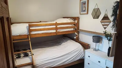 a bedroom with two bunk beds in a room at Cosy cottage near Thornhill in Closeburn