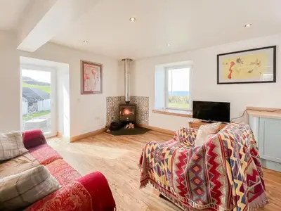 a living room with a couch and a fireplace at The Cheese Loft in Drummore