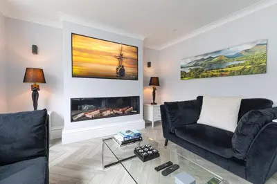 a living room with two couches and a fireplace at Stunning 2 bedroom Apartment in Central Keswick in Keswick