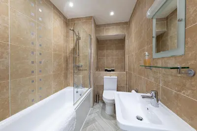 a bathroom with a sink and a tub and a toilet at Stunning 2 bedroom Apartment in Central Keswick in Keswick