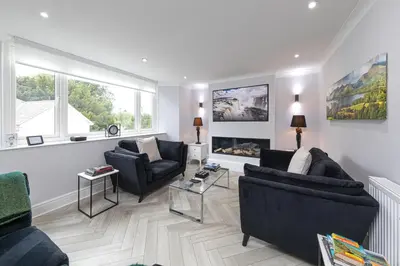 a living room with two couches and two chairs at Stunning 2 bedroom Apartment in Central Keswick in Keswick