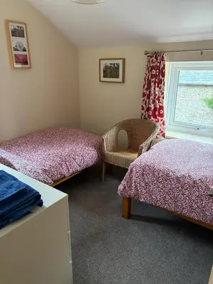 a bedroom with two beds and a window at Pottery Cottage - close to the Lake District in Skelton