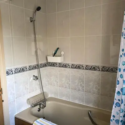 a bathroom with a bath tub with a shower at Pottery Cottage - close to the Lake District in Skelton