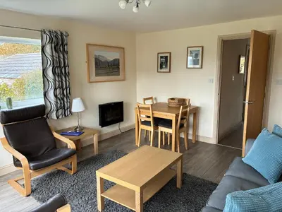 a living room with a table and a dining room at Pottery Cottage - close to the Lake District in Skelton