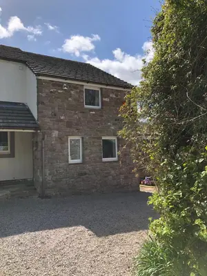 a brick house with two windows on it at Pottery Cottage - close to the Lake District in Skelton