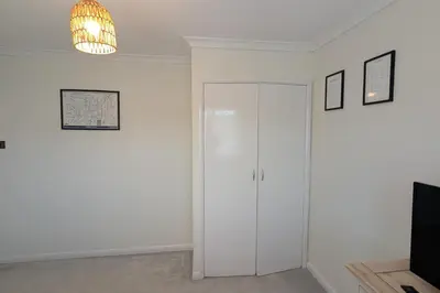 a white room with a closet and a chandelier at 3 Bed-Sleeps 5-Garden-Parking-Pets in Carlisle
