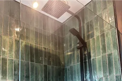 a bathroom with a shower with green tiles at 3 Bed-Sleeps 5-Garden-Parking-Pets in Carlisle