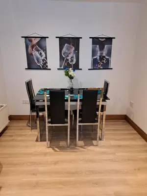 a dining room with a table and chairs in a room at 2 Hares Den in Annan