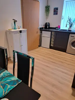 a kitchen with a table and a counter top at 2 Hares Den in Annan