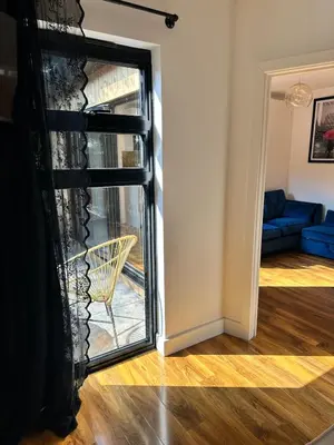 a door leading to a living room with a chair at Scotney Retreat in Moffat